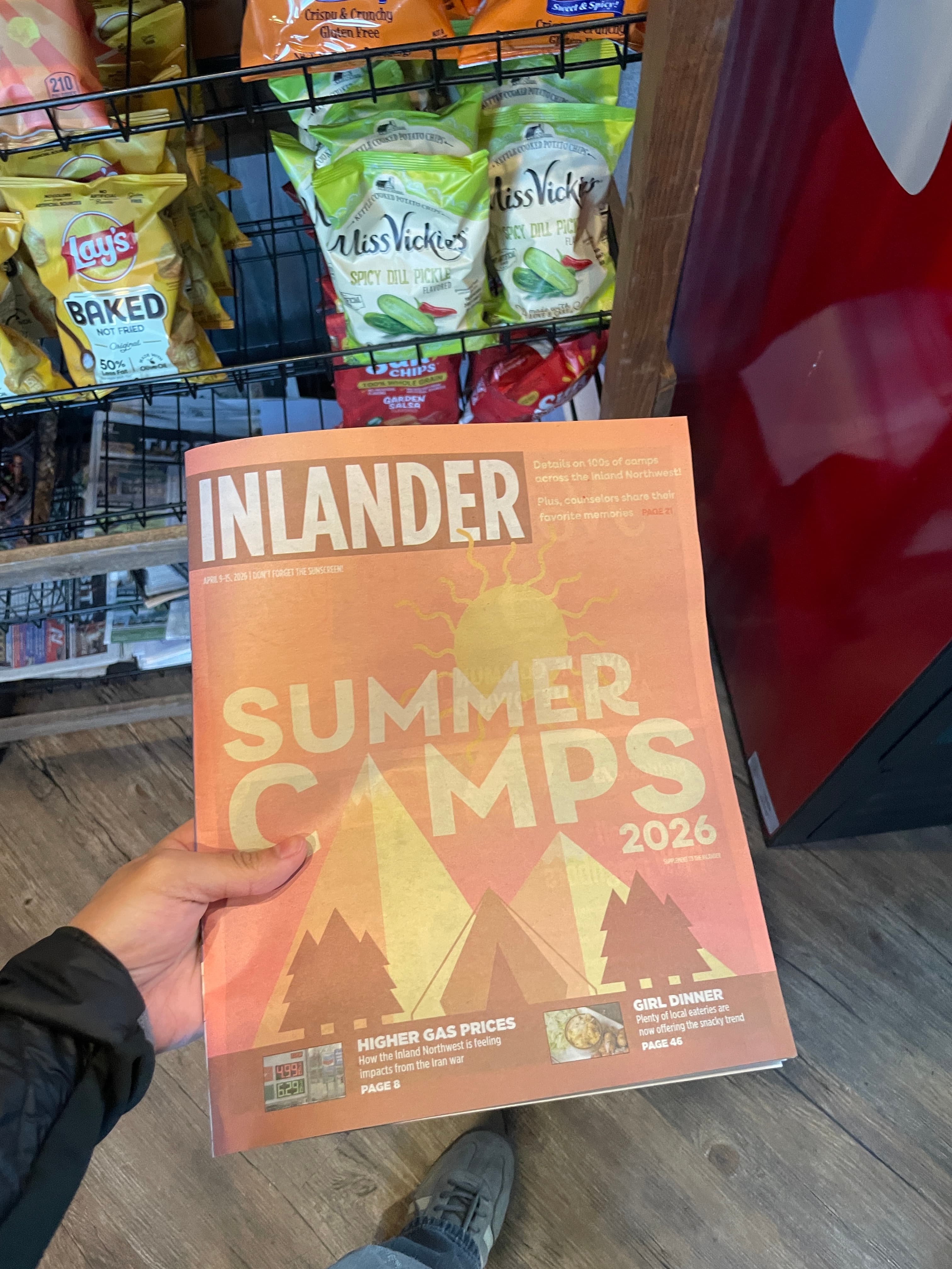 A person holding an Inlander newspaper